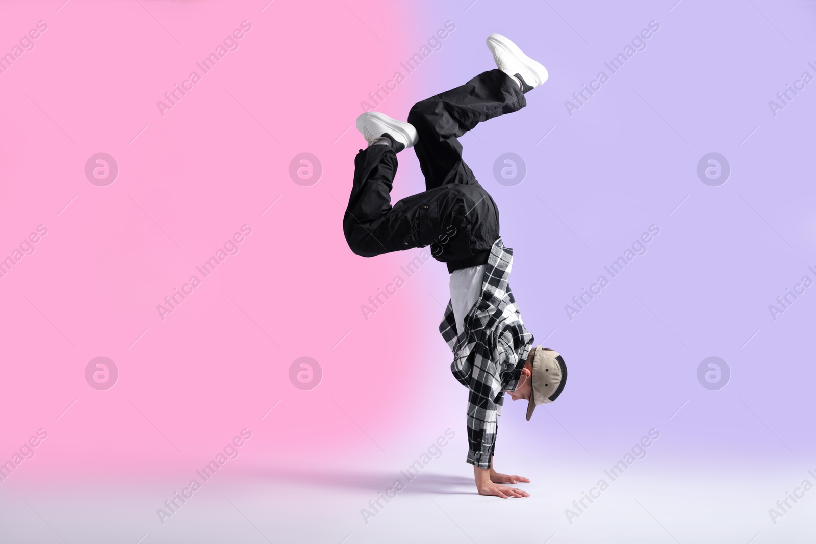 Boy in stylish clothes dancing on color background, space for text Photo of Boy in stylish clothes dancing on color background, space for text