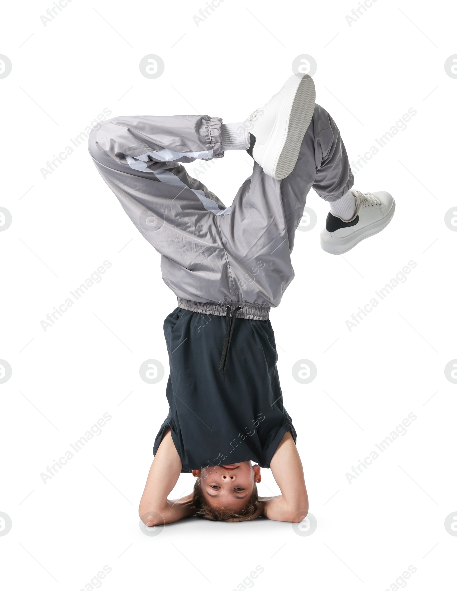 Boy in stylish clothes dancing on white background Photo of Boy in stylish clothes dancing on white background