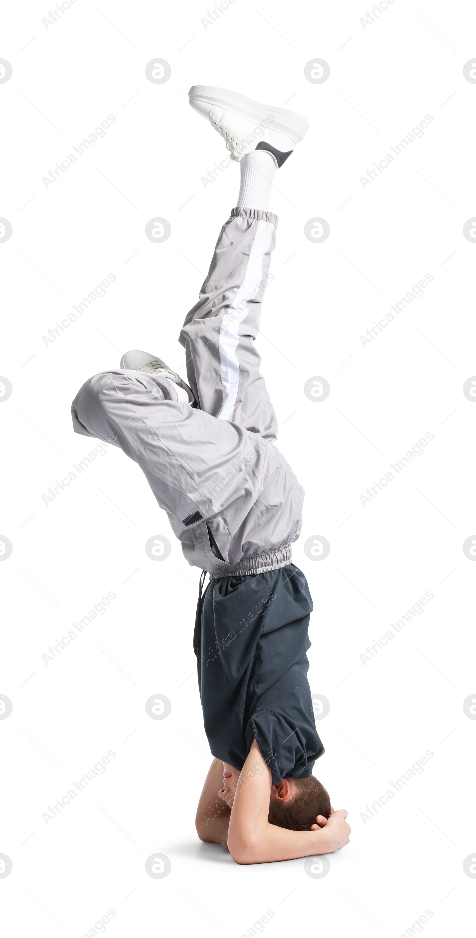Boy in stylish clothes dancing on white background Photo of Boy in stylish clothes dancing on white background