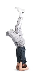 Photo of Boy in stylish clothes dancing on white background