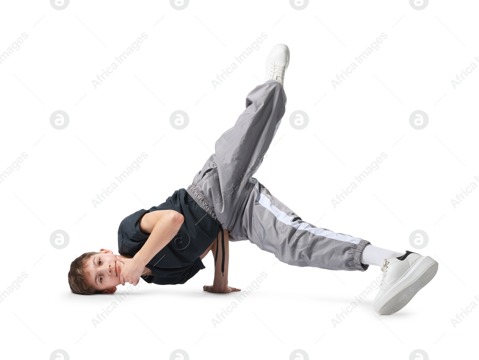 Boy in stylish clothes dancing on white background Photo of Boy in stylish clothes dancing on white background