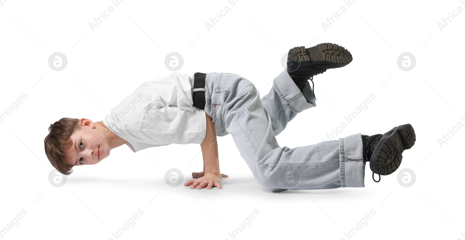 Boy in stylish clothes dancing on white background Photo of Boy in stylish clothes dancing on white background