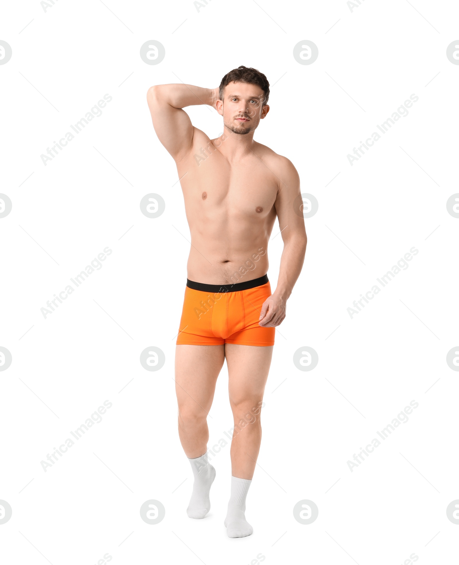 Young man in stylish orange underwear on white background Photo of Young man in stylish orange underwear on white background