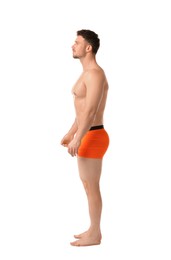 Photo of Young man in stylish orange underwear on white background