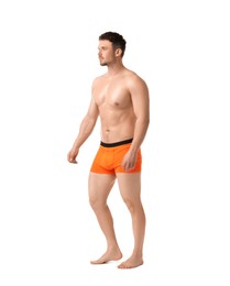Photo of Young man in stylish orange underwear on white background