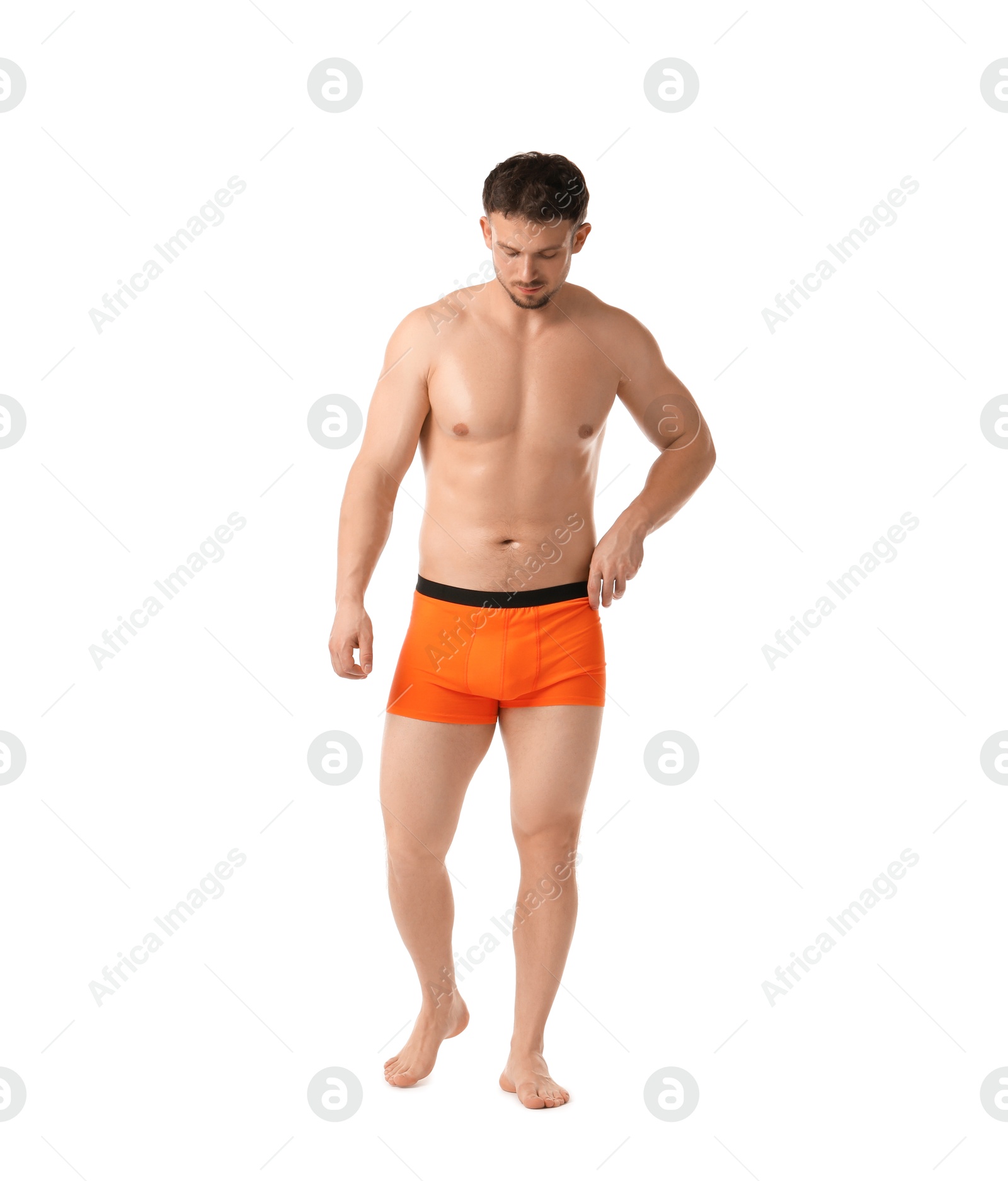 Young man in stylish orange underwear on white background Photo of Young man in stylish orange underwear on white background