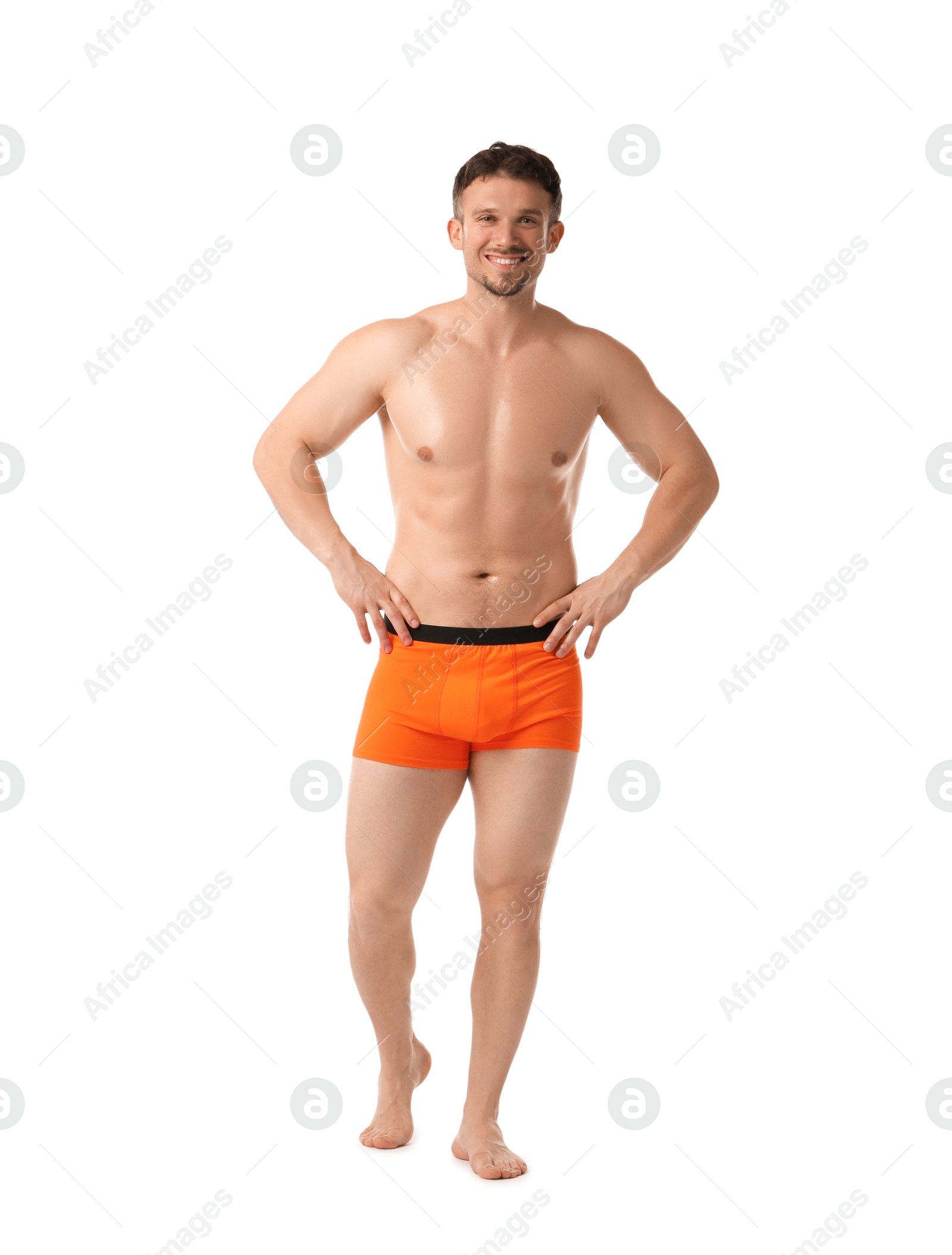 Young man in stylish orange underwear on white background Photo of Young man in stylish orange underwear on white background