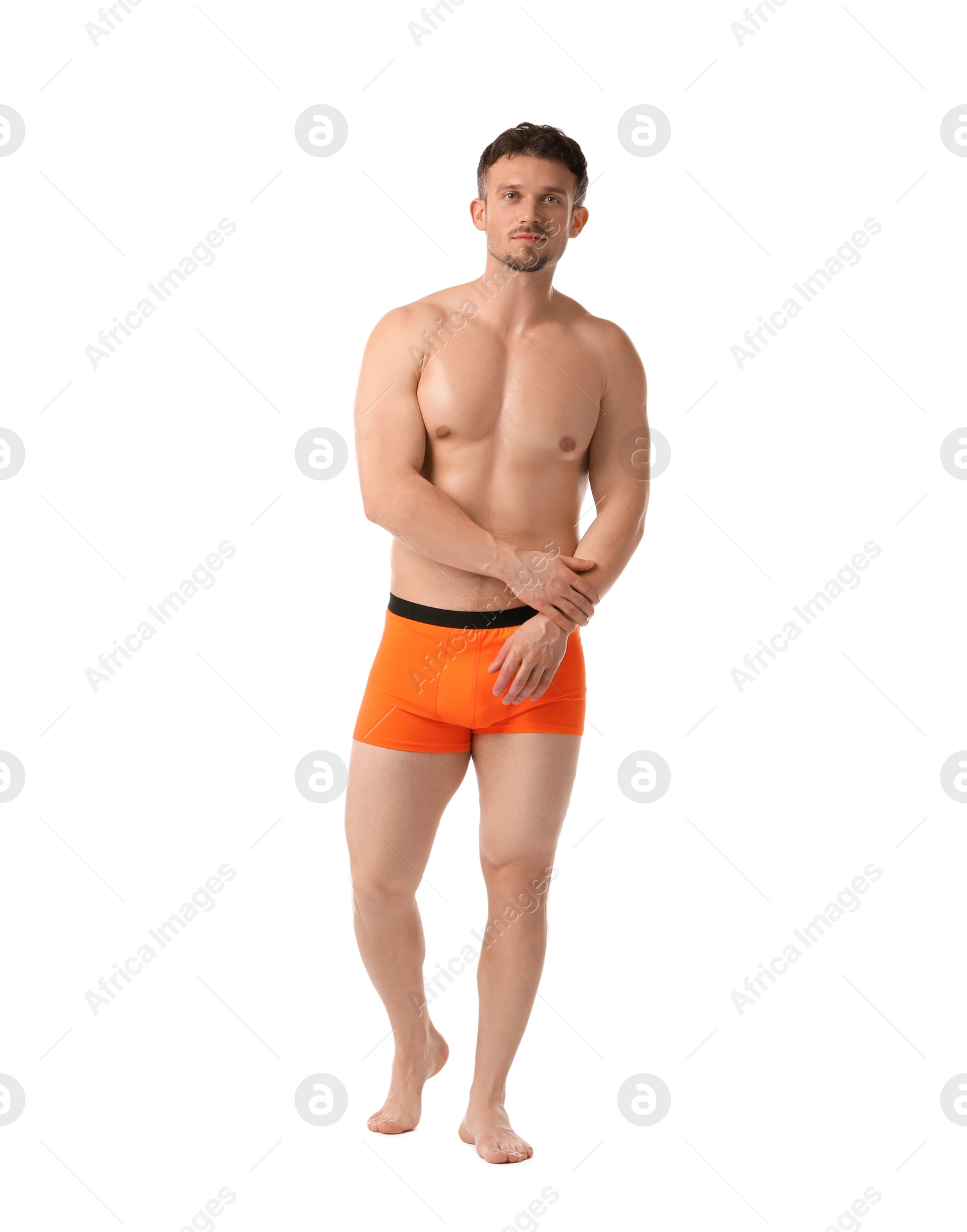 Young man in stylish orange underwear on white background Photo of Young man in stylish orange underwear on white background