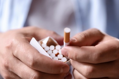Photo of Man taking cigarette out of pack, closeup. Smoking