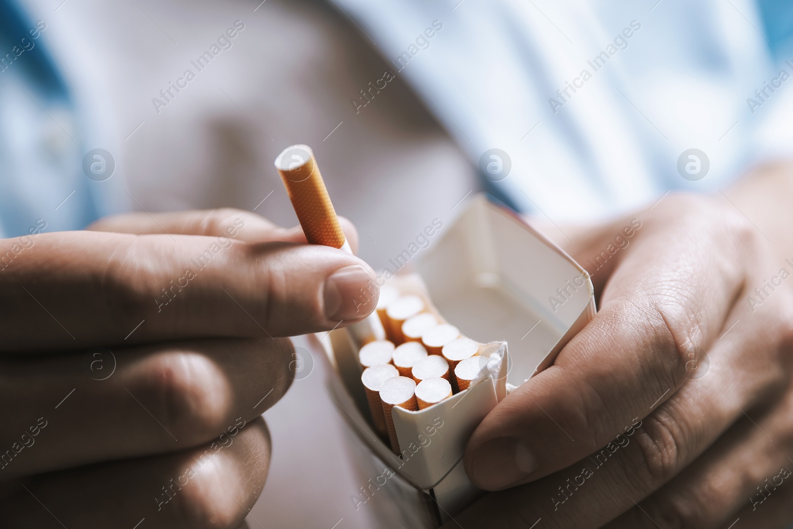 Man taking cigarette out of pack, closeup. Smoking Photo of Man taking cigarette out of pack, closeup. Smoking