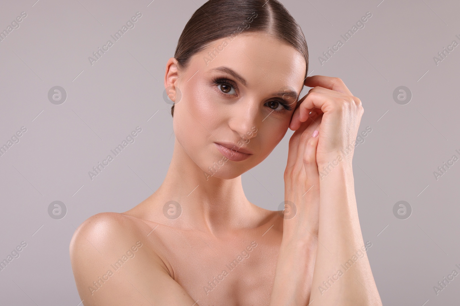Portrait of beautiful young woman on gray background Photo of Portrait of beautiful young woman on gray background