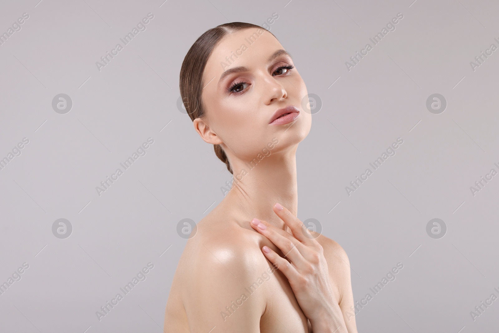 Portrait of beautiful young woman on gray background Photo of Portrait of beautiful young woman on gray background