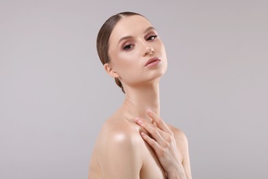 Photo of Portrait of beautiful young woman on gray background