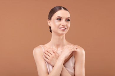 Photo of Portrait of beautiful young woman on beige background