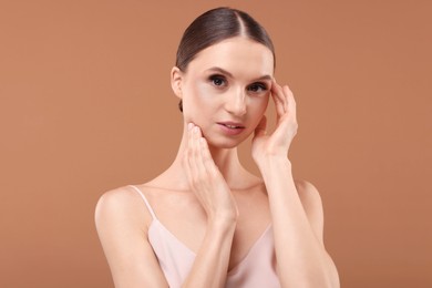 Photo of Portrait of beautiful young woman on beige background