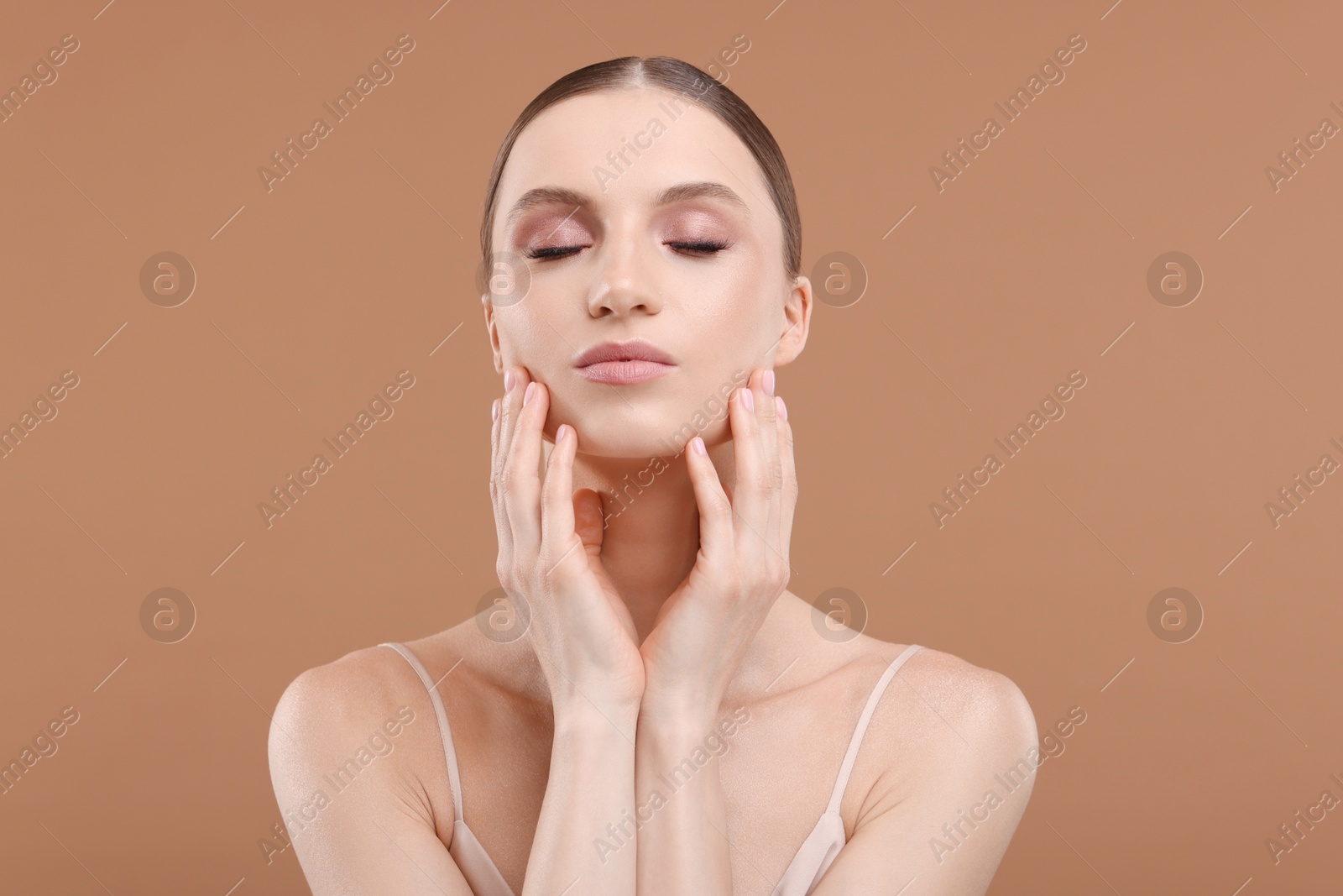 Portrait of beautiful young woman on beige background Photo of Portrait of beautiful young woman on beige background