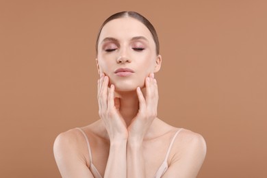 Photo of Portrait of beautiful young woman on beige background