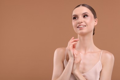 Photo of Portrait of beautiful young woman on beige background, space for text