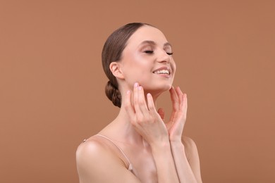 Photo of Portrait of beautiful young woman on beige background