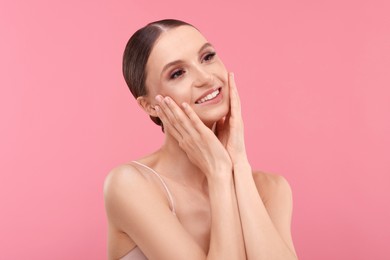 Photo of Portrait of beautiful young woman on pink background