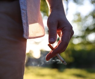 Photo of Man with cigarette in park, closeup view
