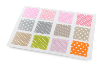 Photo of Samples of fabrics with polka dot pattern isolated on white