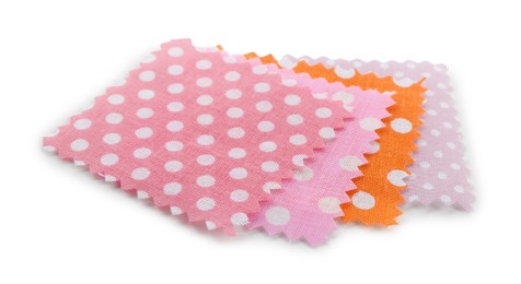 Photo of Samples of fabrics with polka dot pattern isolated on white