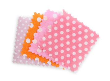 Photo of Samples of fabrics with polka dot pattern isolated on white, top view
