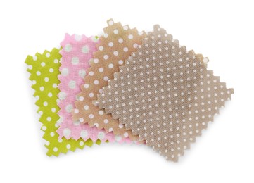 Photo of Samples of fabrics with polka dot pattern isolated on white, top view