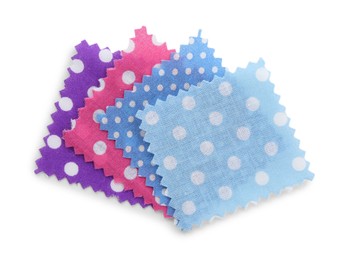 Photo of Samples of fabrics with polka dot pattern isolated on white, top view