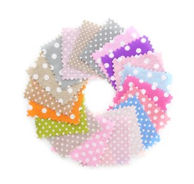 Photo of Samples of fabrics with polka dot pattern isolated on white, top view