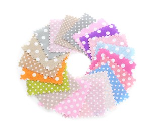 Photo of Samples of fabrics with polka dot pattern isolated on white, top view