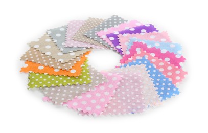 Photo of Samples of fabrics with polka dot pattern isolated on white