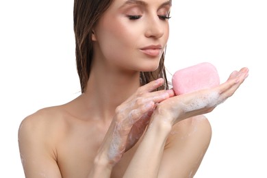 Photo of Woman with foaming soap bar on white background, closeup