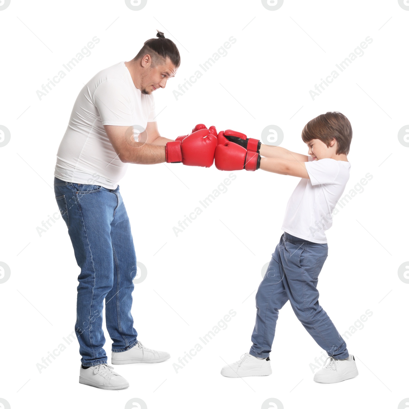 Father and his son boxing on white background Photo of Father and his son boxing on white background