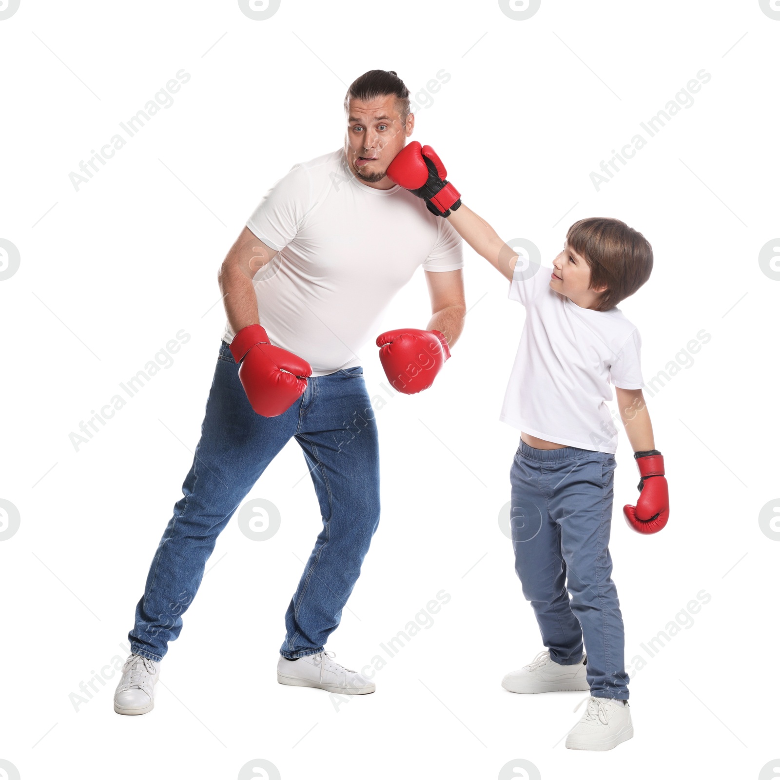 Father and his son boxing on white background Photo of Father and his son boxing on white background