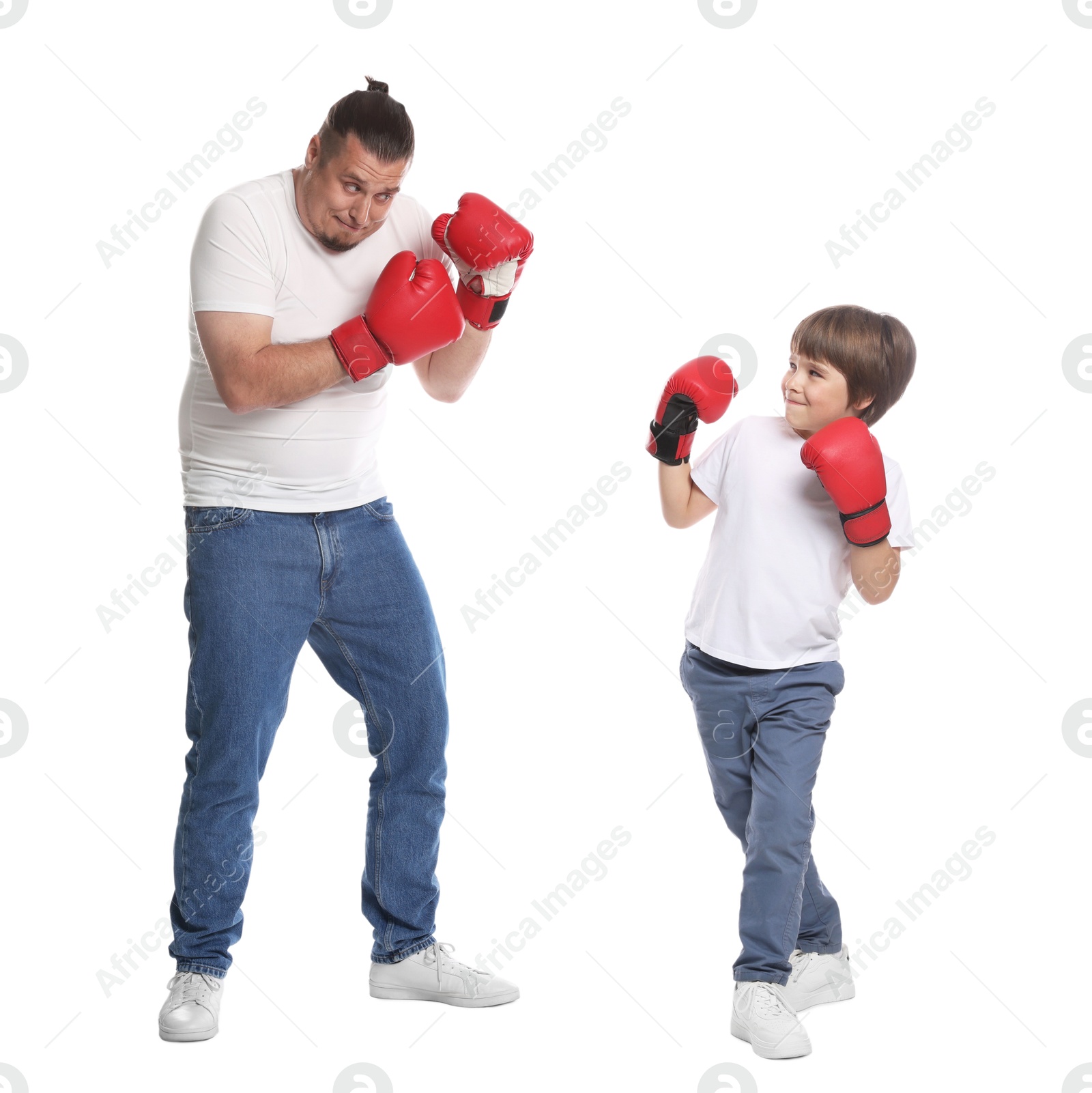 Father and his son boxing on white background Photo of Father and his son boxing on white background
