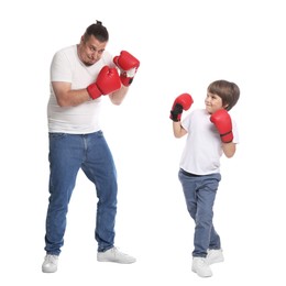 Photo of Father and his son boxing on white background