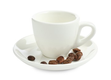 Photo of Ceramic cup with roasted coffee beans isolated on white