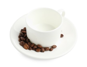 Photo of Ceramic cup with roasted coffee beans isolated on white