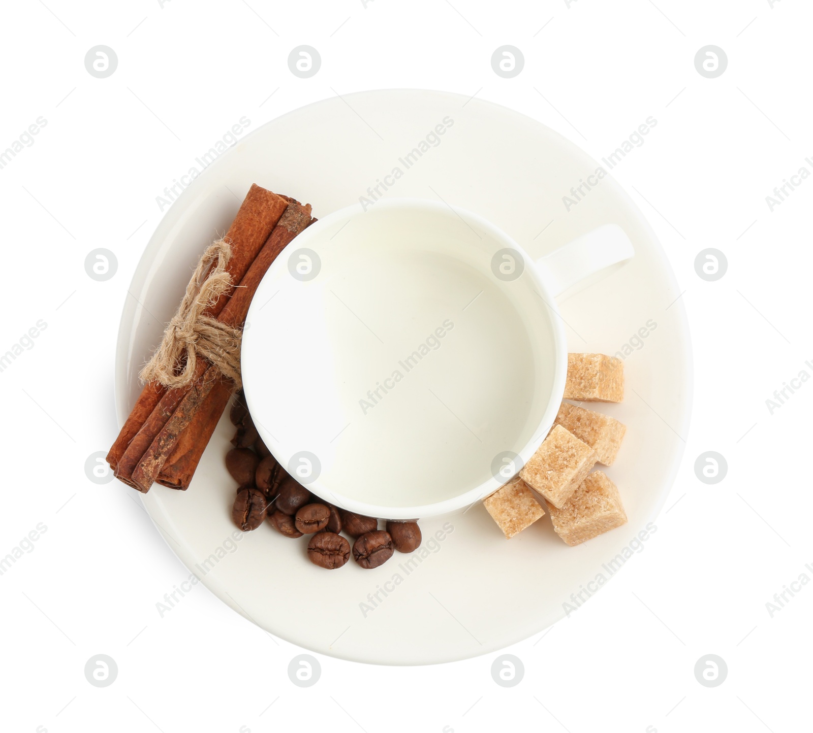 Ceramic cup with roasted coffee beans, sugar and cinnamon isolated on white, top view Photo of Ceramic cup with roasted coffee beans, sugar and cinnamon isolated on white, top view
