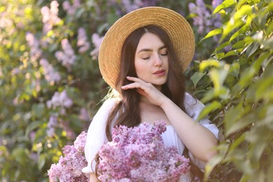 Photo of Beautiful woman among lilac flowers and leaves outdoors