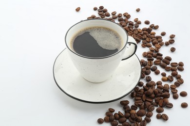 Photo of Aromatic coffee in cup and beans isolated on white