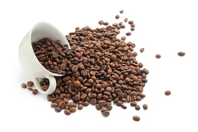 Photo of Aromatic coffee beans and cup isolated on white, above view