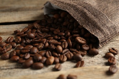 Photo of Aromatic coffee beans on wooden table, closeup