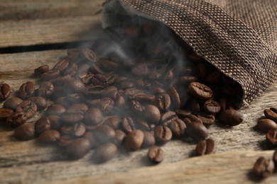 Photo of Aromatic coffee beans on wooden table, closeup