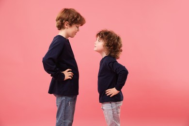 Photo of Two cute little brothers on pink background