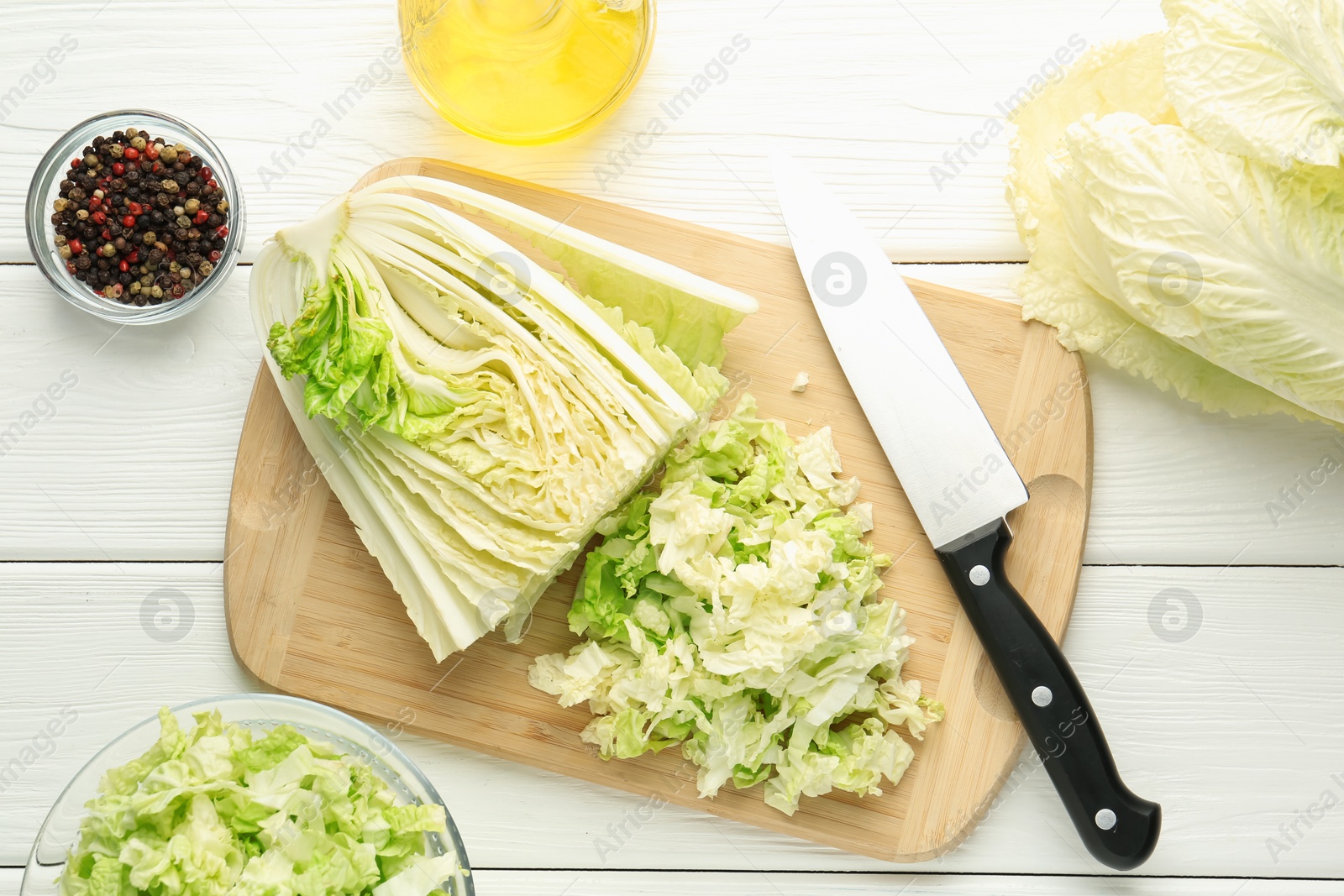 Cut Chinese cabbage and knife on white wooden table, flat lay Photo of Cut Chinese cabbage and knife on white wooden table, flat lay