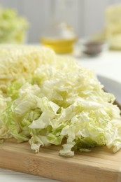 Photo of Cut Chinese cabbage on white table, closeup