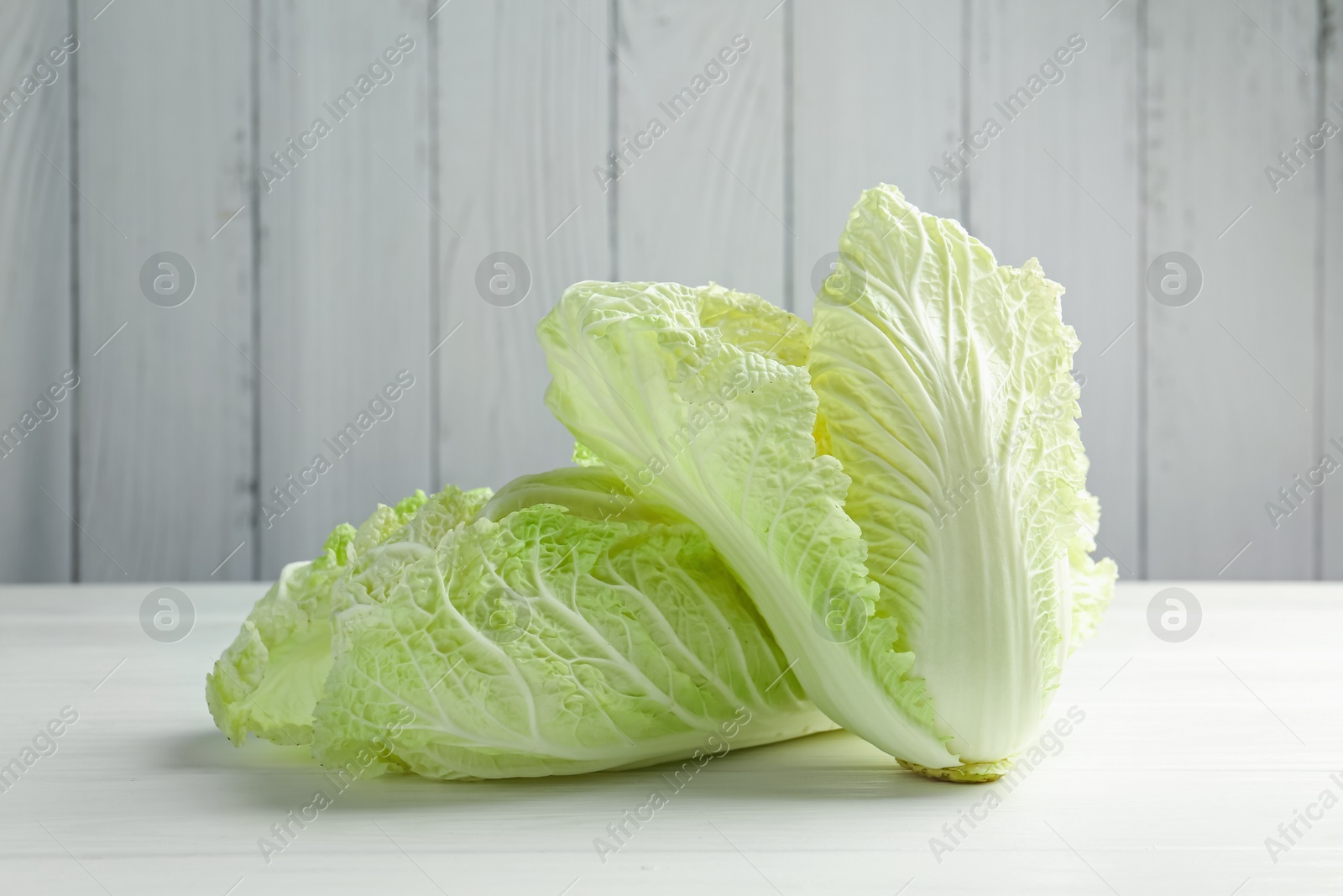 Fresh Chinese cabbages on white wooden table, closeup Photo of Fresh Chinese cabbages on white wooden table, closeup